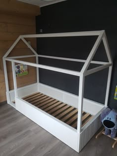 there is a bed with a house shaped frame on the top and bottom bunk below it