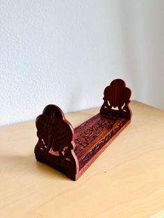 a wooden bench sitting on top of a table