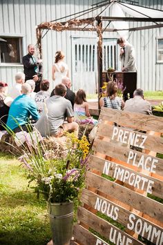 a group of people sitting around a wooden sign