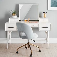 a white desk with a mirror and chair in front of it on a hard wood floor