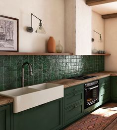 a kitchen with green cabinets and a white sink