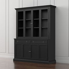 a wooden cabinet with glass doors on the top and bottom, against a white wall