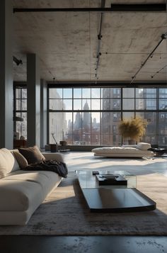 a living room filled with lots of furniture next to large windows and floor to ceiling windows