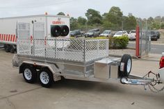 the trailer is parked on the side of the road in front of some parking spaces