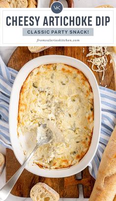 cheesy artichoke dip in a white bowl on a wooden cutting board