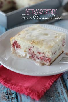 a piece of strawberry sour cream cake on a white plate with a pink napkin next to it