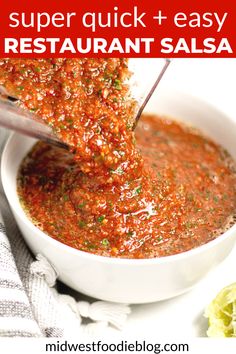 a white bowl filled with red sauce on top of a table