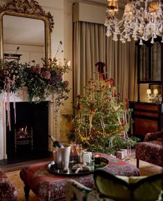 a living room filled with furniture and a christmas tree in the middle of the room