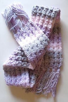 two knitted scarves laying on top of each other