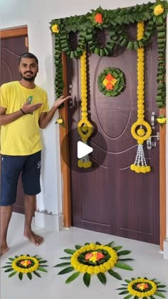 a man standing in front of a door decorated with flowers and garlands on it