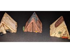 three pieces of wood that have been carved to look like mountains