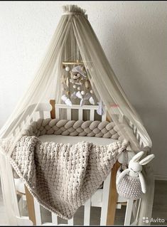 a crib with a blanket and stuffed animals in it