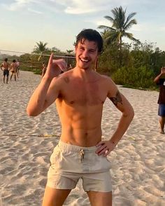 a man standing on top of a sandy beach