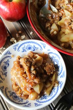 two bowls filled with apples and some oatmeal on top of a table