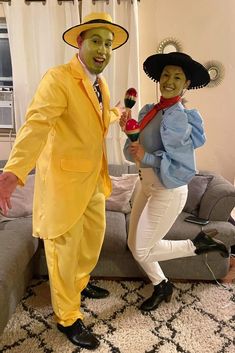 two people dressed in costumes standing next to each other