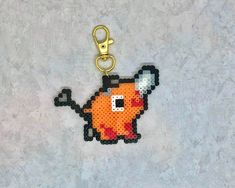 a pixel art keychain with an image of a pikachu on it