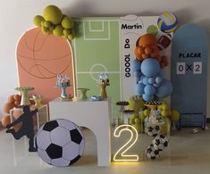 a soccer themed birthday party with balloons, decorations and table numbers for the boys'first birthday