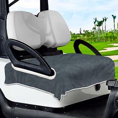 a white and black golf cart with the seat up