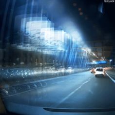 a car driving down a city street at night