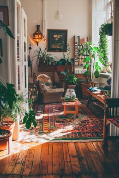 a living room filled with furniture and lots of plants on top of wooden flooring