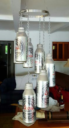 a chandelier made out of cans hanging from the ceiling