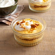 two desserts in small glass dishes on a wooden table