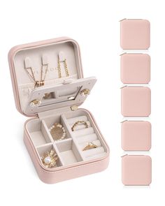 an open pink jewelry box filled with rings and bracelets