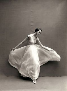 a black and white photo of a woman in a dress