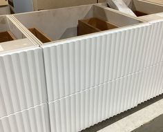 a white radiator sitting on top of a floor next to boxes and cardboard