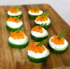 cucumber bites with caviar and white cream on them are ready to be eaten