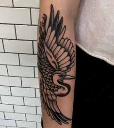 a woman with a bird tattoo on her arm