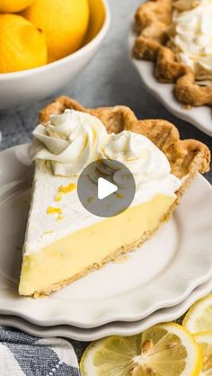 a slice of lemon pie with whipped cream on top and sliced lemons in the background