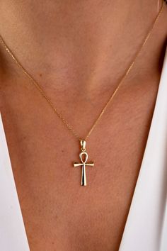 "This 14K gold cross necklace is a beautiful and meaningful piece of jewelry that would make a perfect gift for any occasion. The crucifix pendant is a symbol of faith and devotion, and would be a thoughtful present for a loved one on Christmas, Father's Day, Mother's Day, Valentine's Day, an anniversary, or a birthday. The necklace features a small and dainty cross charm that hangs from a delicate chain, making it perfect for those who prefer a more subtle and discreet look. It would be a suita Spiritual 14k Gold Cross Jewelry, 14k Gold Cross Necklace For Spiritual Wear, Spiritual 14k Gold Crucifix Necklace, Symbolic Yellow Gold Cross Jewelry, Symbolic Yellow Gold Cross Necklace, Spiritual Cross Necklace In Yellow Gold, Spiritual Yellow Gold Cross Necklaces, 14k Gold Spiritual Cross Necklace, Symbolic Crucifix Cross Necklace As Gift