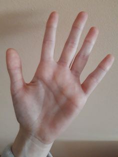 a person holding their hand up in the air