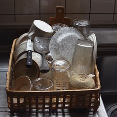 a basket filled with dishes sitting on top of a counter