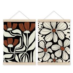 two wall hangings with flowers and leaves on the same wall, one is black and white