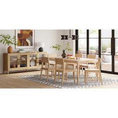 a dining room table and chairs in front of a sliding glass door