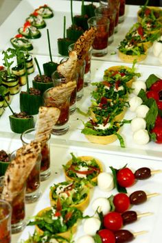 many small appetizers are lined up on the table