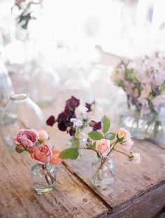 several vases with flowers are sitting on a table