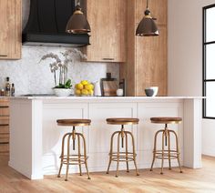 three stools in front of a kitchen island