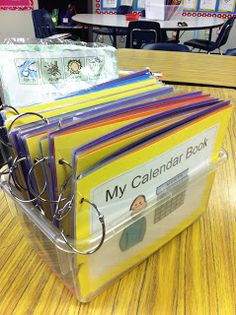 a stack of folders sitting on top of a wooden table