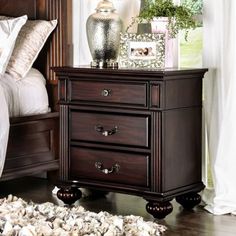 a night stand with two drawers on top of it