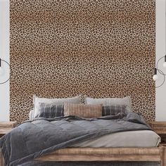 a bedroom with a leopard print wall behind the bed