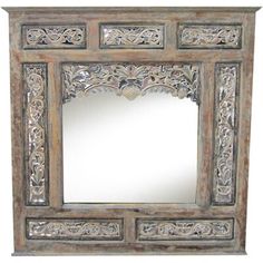 an ornate wooden mirror frame with carvings on it