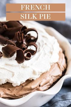 a white bowl filled with whipped cream and chocolate