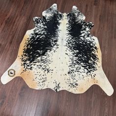 a cowhide rug with black and white spots