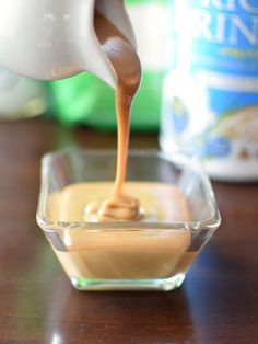 a person pouring peanut butter into a bowl