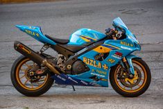 a blue and yellow motorcycle parked on the street