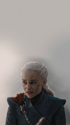 game of thrones character daeneria starke standing in front of a white wall