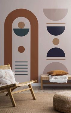 a chair and ottoman in front of a wall with geometric designs on it, along with a round rug